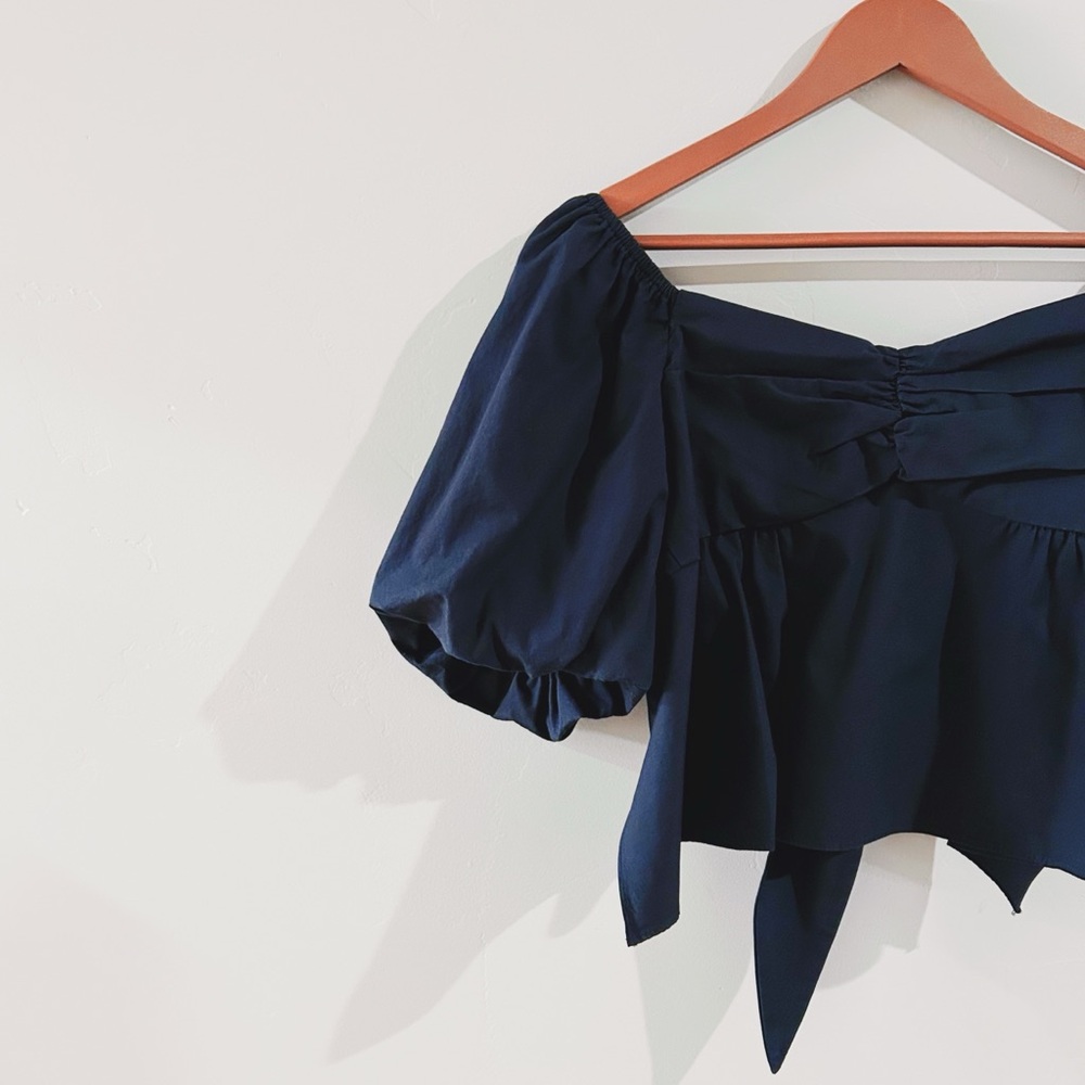 the great eros | puff-sleeve tie-back blouse in black ↷